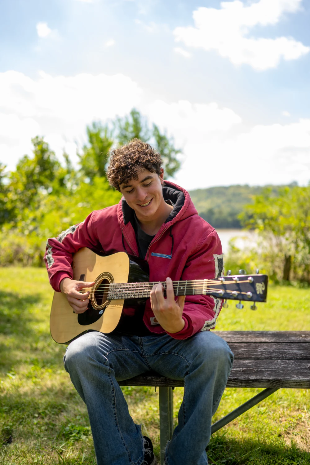 Ryan playing acoustic guitar outdoors